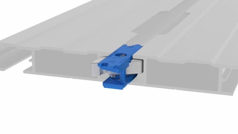 Rhino Rack Zwifloc channel nut clipped into a roof rack channel, showing the blue retention clip and stainless hardware