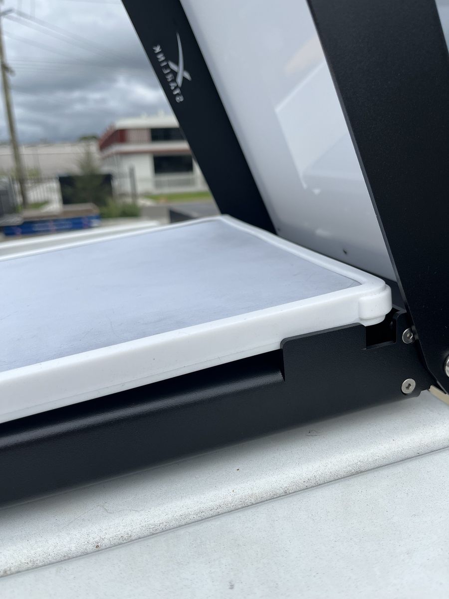 Close-up of the Starlink Mini's rounded corner seated snugly in the Power Hub's corner lock