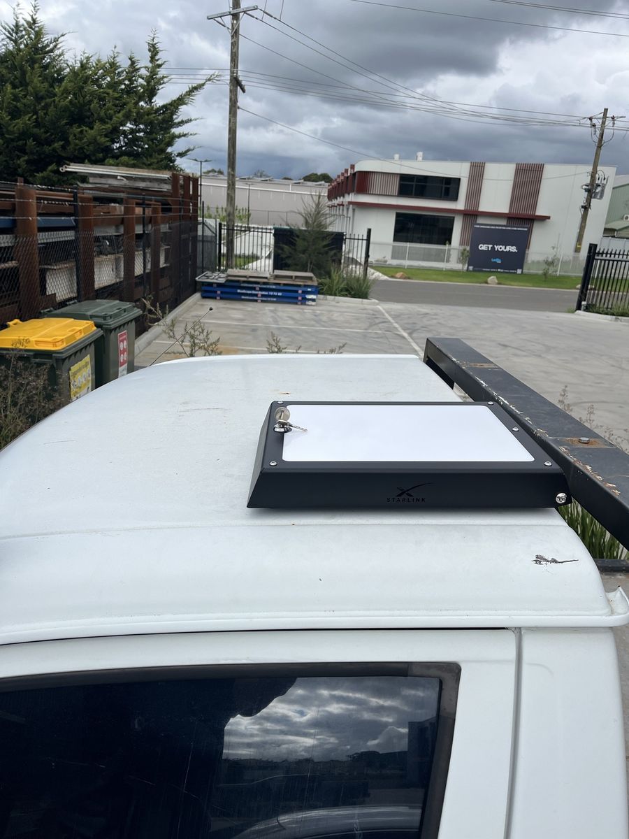 Power Hub bolted to the roof of a white ute canopy with the lid shut and the key in the lock